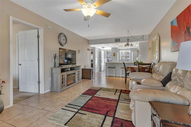 tiled living room with ceiling fan