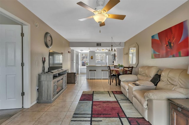 tiled living room featuring ceiling fan