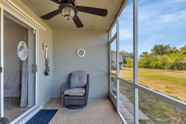 sunroom / solarium featuring ceiling fan