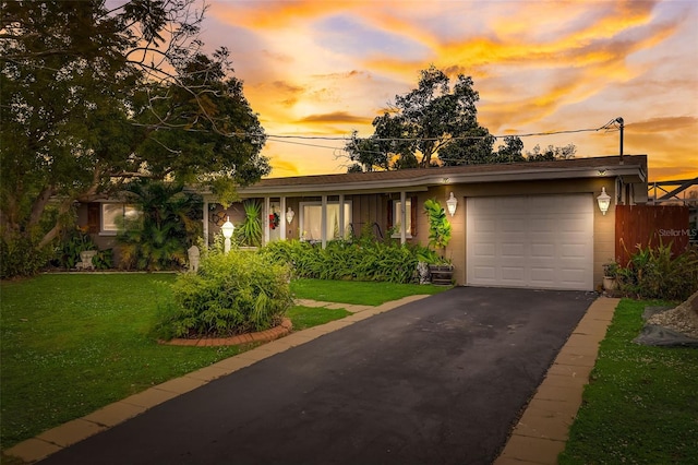 view of front of property with a lawn and a garage