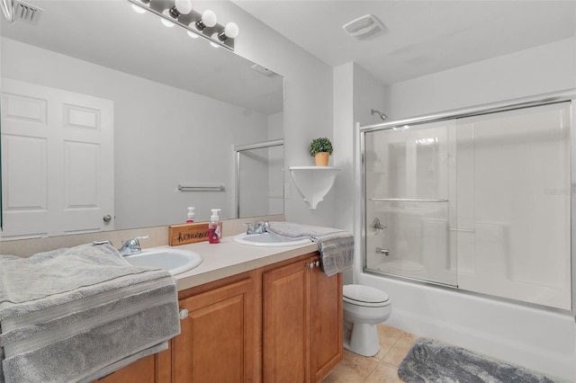 full bathroom with enclosed tub / shower combo, tile patterned floors, toilet, and vanity