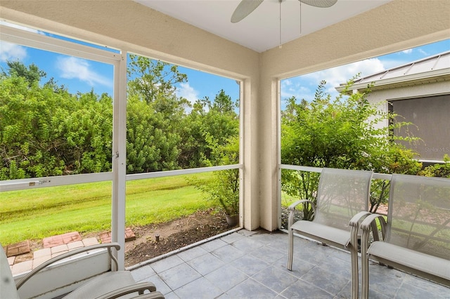 unfurnished sunroom featuring ceiling fan