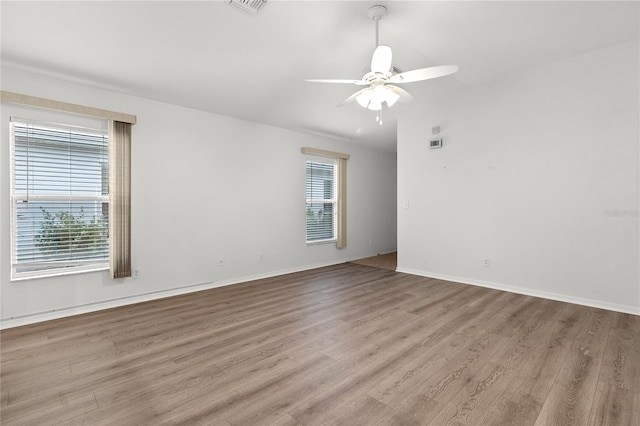 spare room with ceiling fan and light wood-type flooring