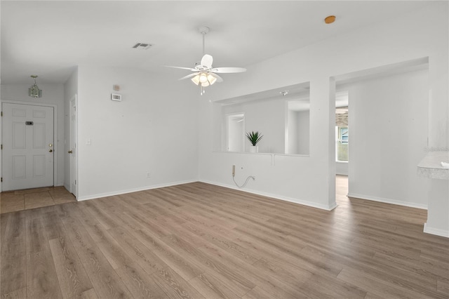 empty room featuring lofted ceiling, light hardwood / wood-style flooring, and ceiling fan