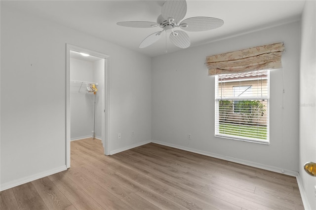 empty room featuring ceiling fan and light hardwood / wood-style floors