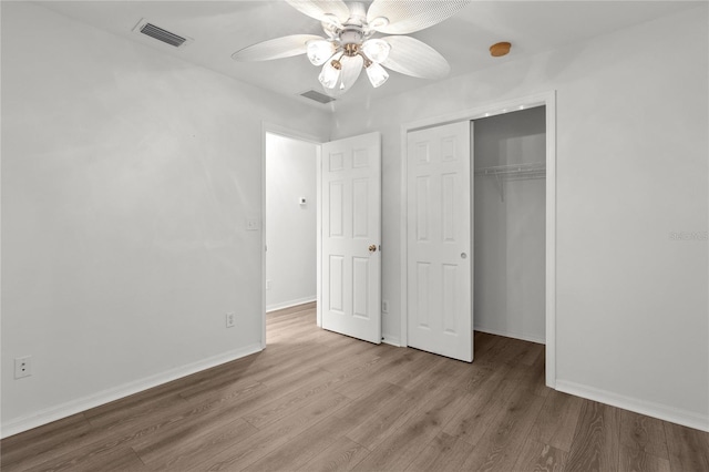 unfurnished bedroom with a closet, ceiling fan, and light wood-type flooring