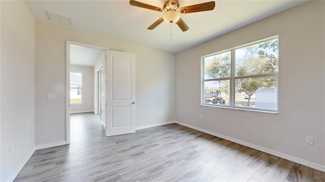 spare room with light hardwood / wood-style floors, plenty of natural light, and ceiling fan