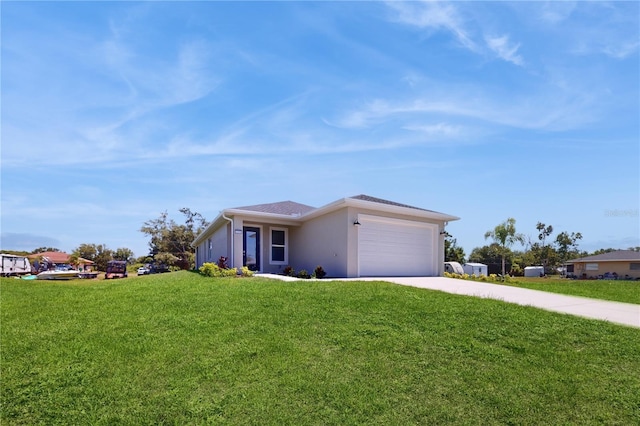 view of front of home with a garage and a front lawn