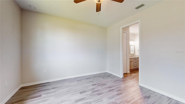 spare room featuring ceiling fan and light hardwood / wood-style floors