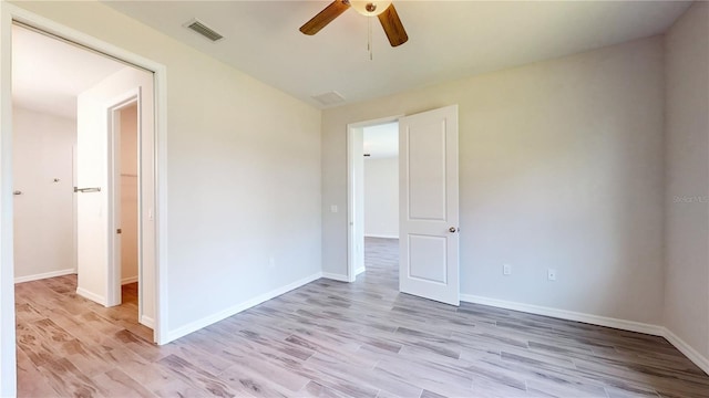 unfurnished room with ceiling fan and light wood-type flooring