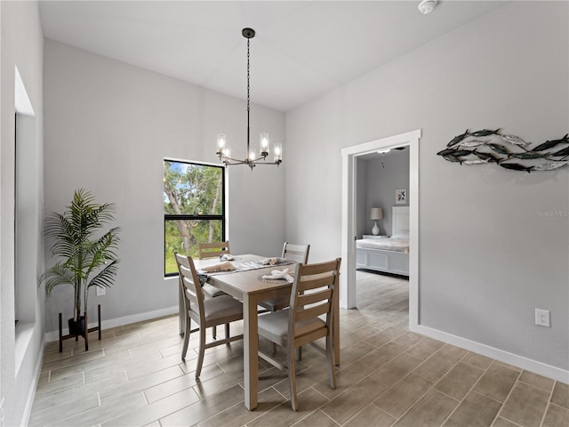 dining area with hardwood / wood-style flooring and an inviting chandelier