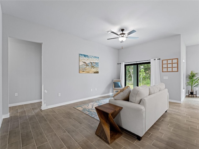 living room featuring ceiling fan and hardwood / wood-style flooring