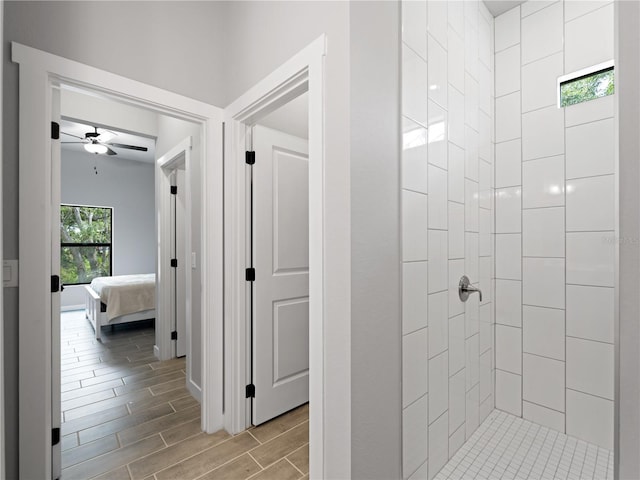 bathroom featuring ceiling fan and tiled shower