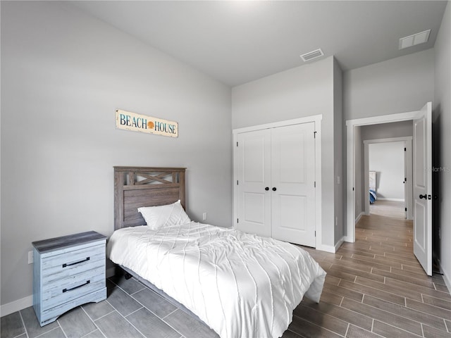 bedroom with a closet and dark wood-type flooring