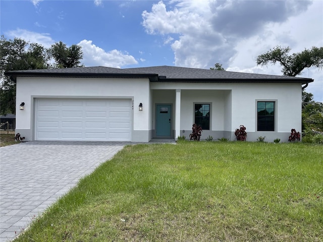 view of front of home with a garage and a front lawn