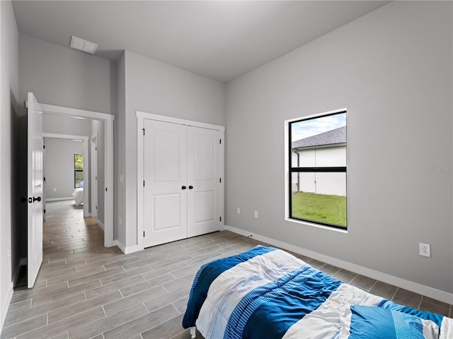 bedroom with multiple windows and a closet