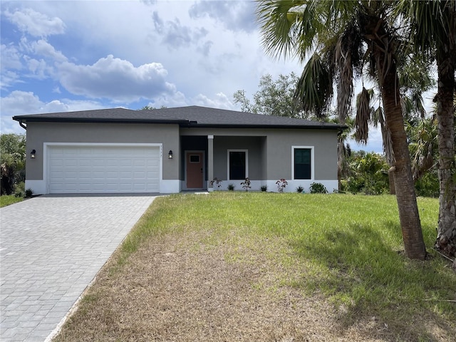 view of front of property featuring a front yard and a garage