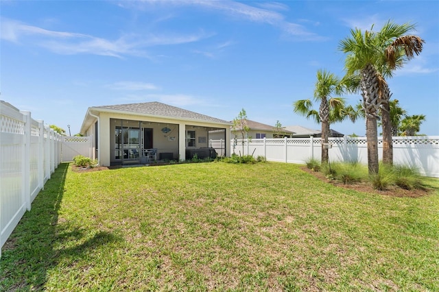 back of house with a lawn and a sunroom