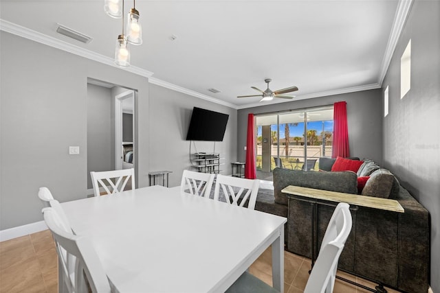 tiled dining room featuring ceiling fan and crown molding