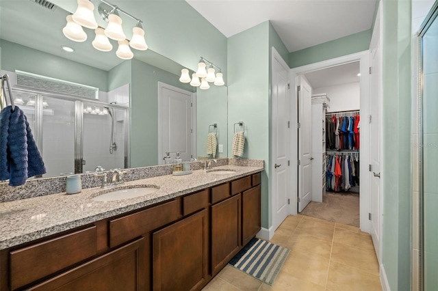 bathroom with vanity, tile patterned floors, and a shower with shower door