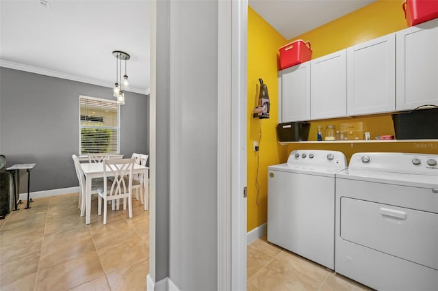 washroom with cabinets, light tile patterned flooring, washing machine and dryer, and ornamental molding