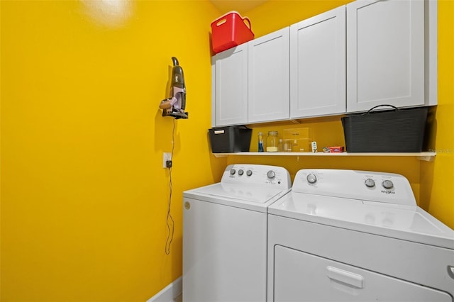 laundry room featuring cabinets and washing machine and dryer