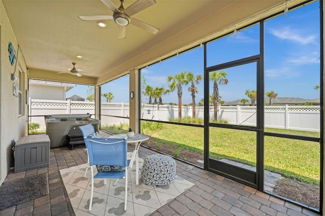 sunroom featuring ceiling fan