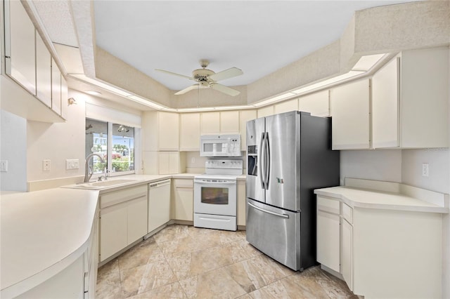 kitchen with ceiling fan, white cabinetry, white appliances, and sink