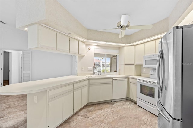 kitchen featuring ceiling fan, sink, white appliances, and kitchen peninsula