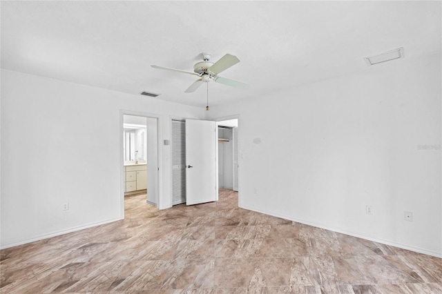 unfurnished bedroom featuring ceiling fan and ensuite bathroom