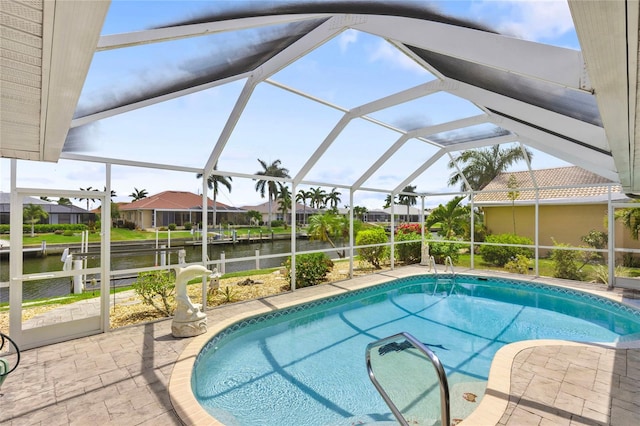 view of swimming pool featuring a water view, glass enclosure, and a patio area