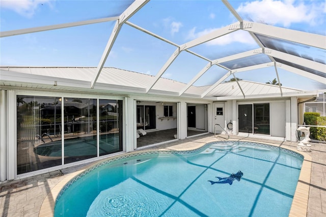 view of swimming pool featuring a patio area and a lanai