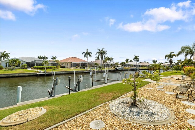 view of dock featuring a yard and a water view