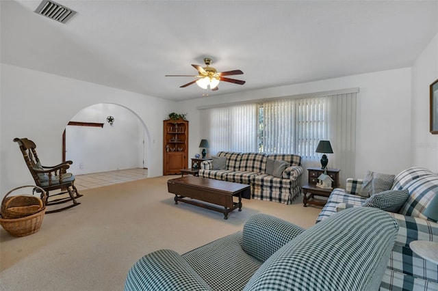 carpeted living room featuring ceiling fan