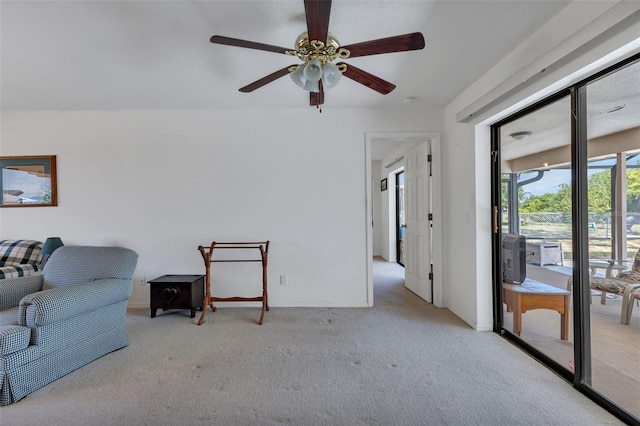 living room featuring light carpet and ceiling fan