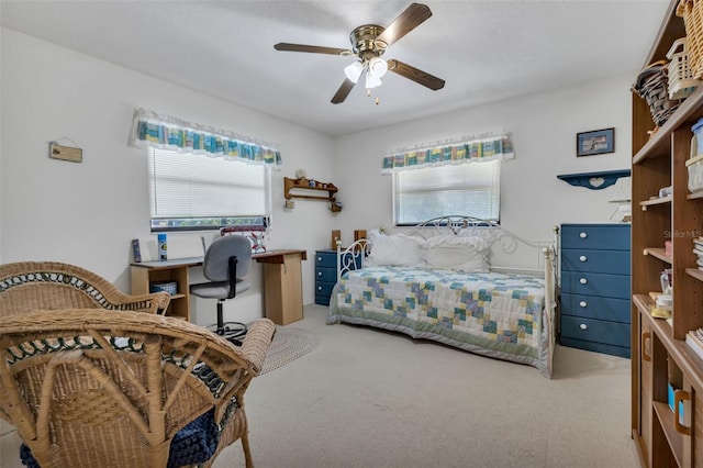 bedroom featuring light carpet and ceiling fan