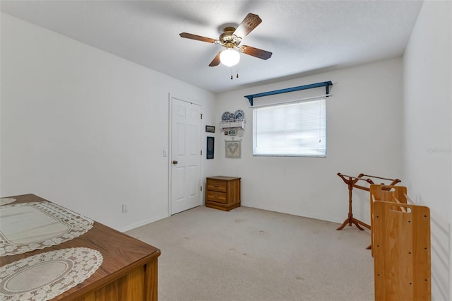 bedroom with light carpet and ceiling fan