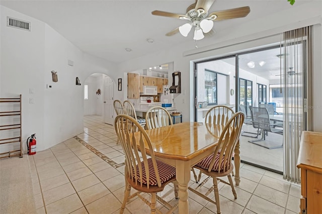 tiled dining room with ceiling fan