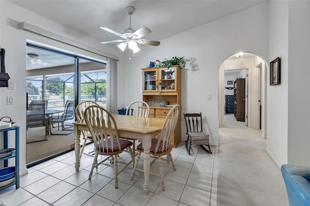 dining area featuring light carpet and ceiling fan