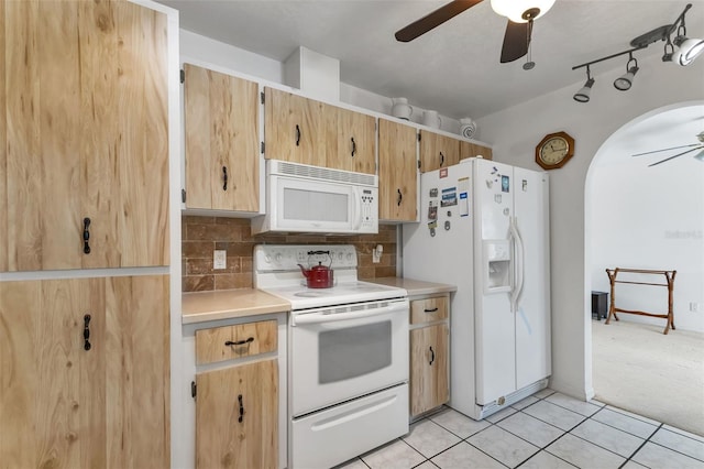 kitchen with decorative backsplash, light tile patterned floors, white appliances, and ceiling fan