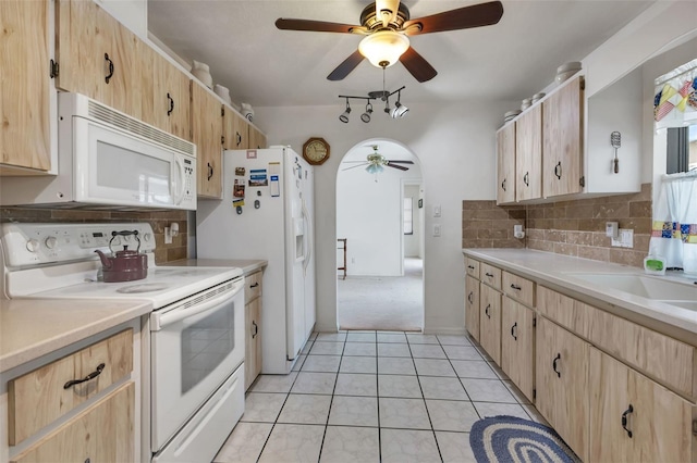 kitchen with decorative backsplash, light tile patterned flooring, white appliances, and light brown cabinetry