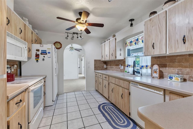 kitchen featuring backsplash, white appliances, sink, light tile patterned floors, and light brown cabinets