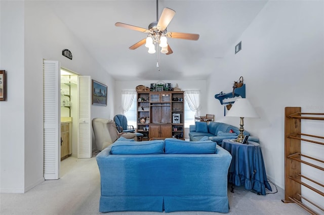 living room with ceiling fan, light carpet, and vaulted ceiling