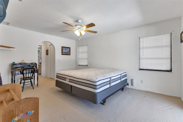 bedroom featuring light carpet and ceiling fan