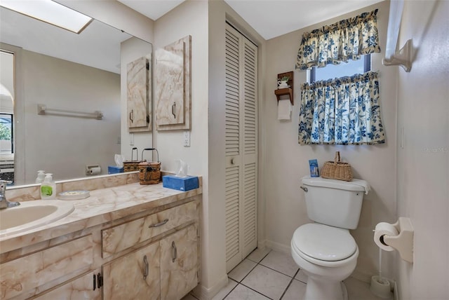 bathroom with tile patterned flooring, vanity, and toilet