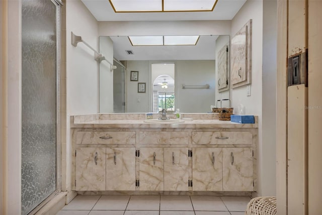 bathroom featuring ceiling fan, tile patterned flooring, vanity, and a shower with shower door