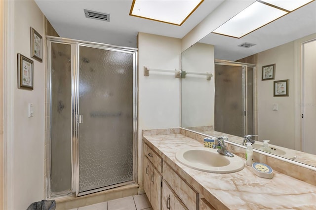 bathroom with tile patterned flooring, vanity, and an enclosed shower