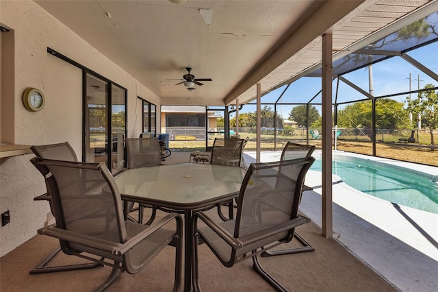 view of patio with glass enclosure and ceiling fan