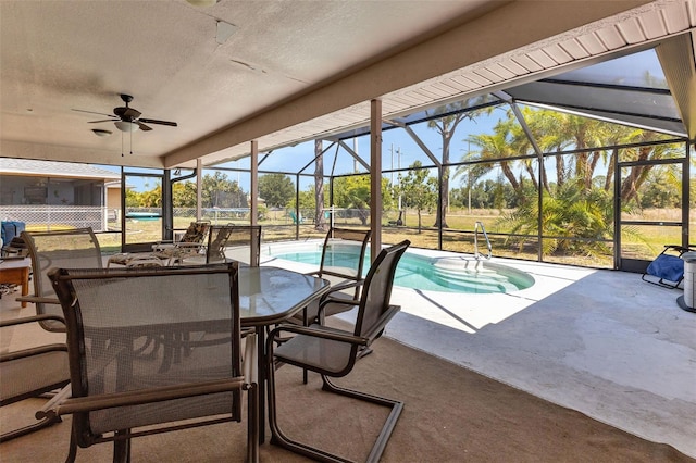 view of swimming pool featuring ceiling fan, a lanai, and a patio