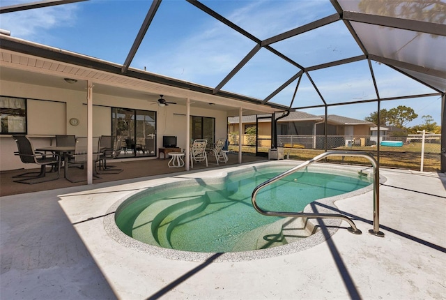 view of pool with glass enclosure, ceiling fan, and a patio